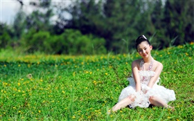 Asian girl sitting in the grass HD wallpaper