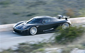 Black Koenigsegg supercar in speed HD wallpaper