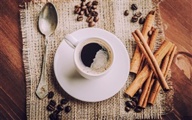 Cup of coffee, saucers, spoon, coffee beans