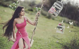 Girl playing swing, long hair, red dress