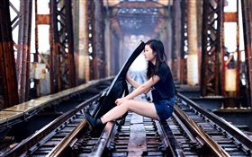 Girl sit at railroad play guitar, bridge HD wallpaper