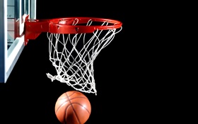 Basketball into the basket, black background HD wallpaper