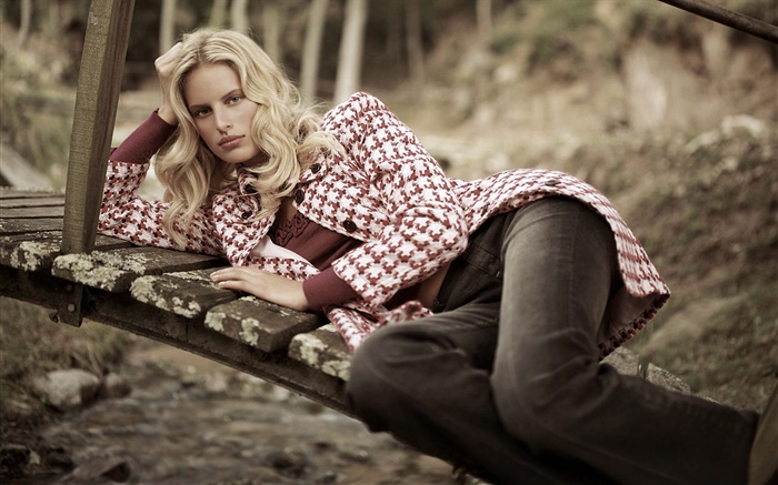 Blonde girl lying on wood bridge, coat Wallpapers Pictures Photos Images