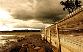 Coast, wood board, stones, clouds