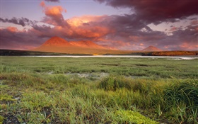 Grass, mountains, clouds, red sky, dusk HD wallpaper