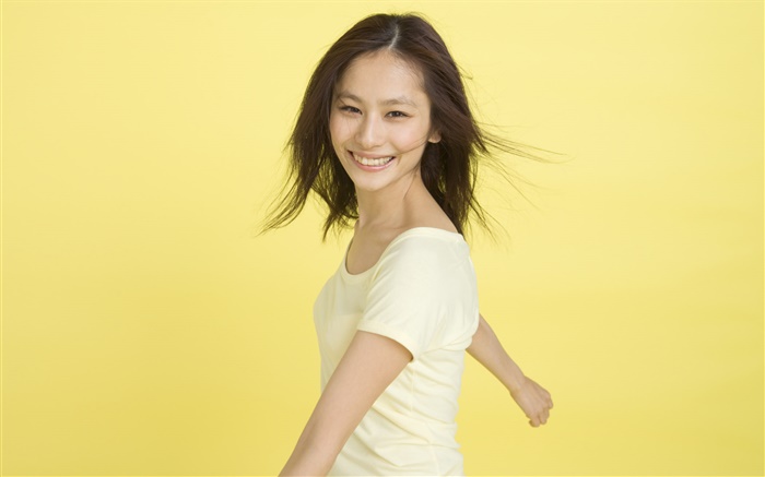 Happy Asian girl, yellow background Wallpapers Pictures Photos Images