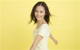 Happy Asian girl, yellow background HD wallpaper