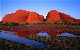 Red rock mountain, water, grass, dusk, Australia