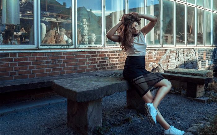 Curly hair girl sit on stone chair Wallpapers Pictures Photos Images