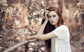 Brown hair girl in autumn, trees, fence